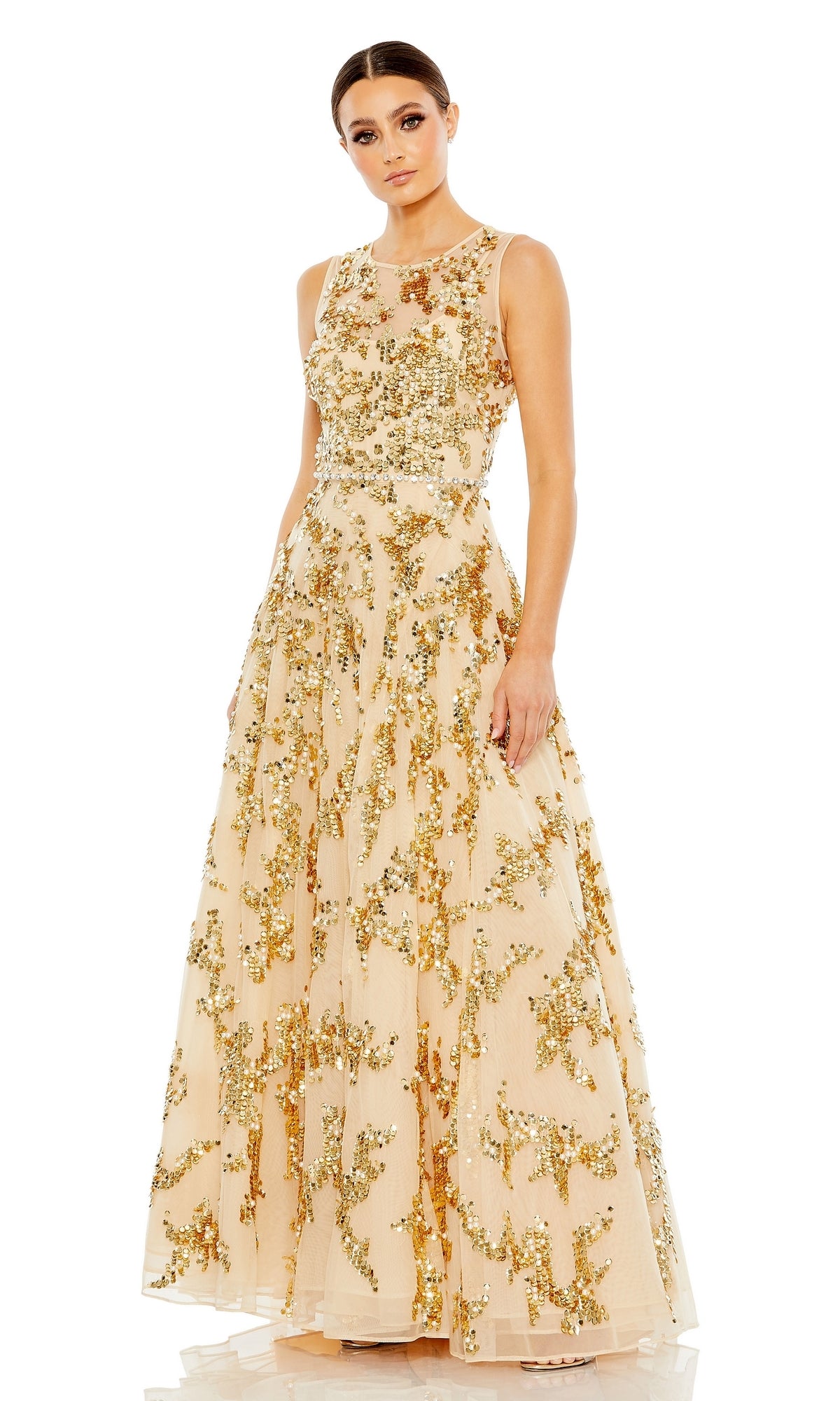 A woman stands facing forward in the Long Formal Dress 10953 by Mac Duggal, featuring a nude A-line silhouette with gold sequin embellishments and a sheer sweetheart neckline.